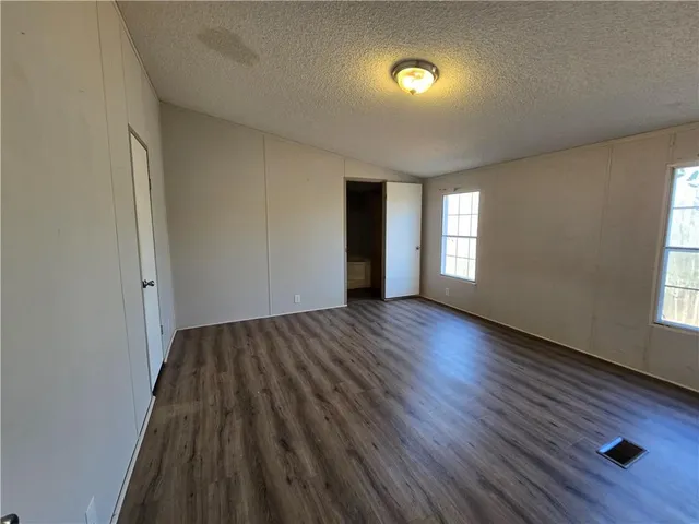 a kitchen with stainless steel appliances granite countertop a sink refrigerator and cabinets