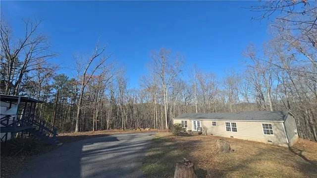 a view of road with large trees