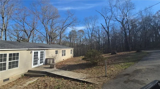 a view of a backyard with large trees