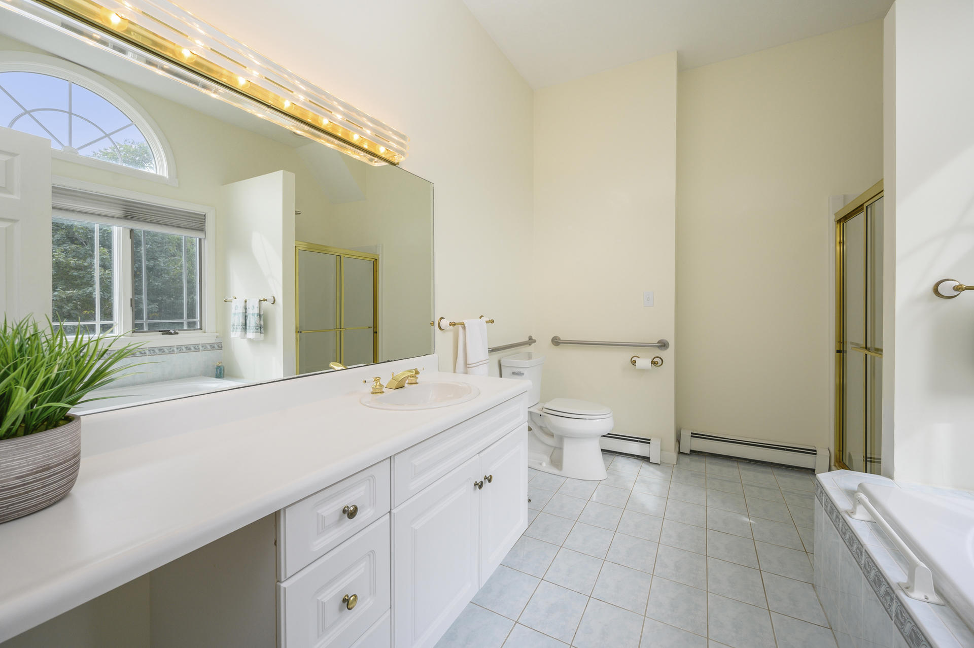 12 Pleasure Point Road Sagamore, MA 02561 - Photo 14 of 29 a spacious bathroom with a granite countertop sink and a mirror