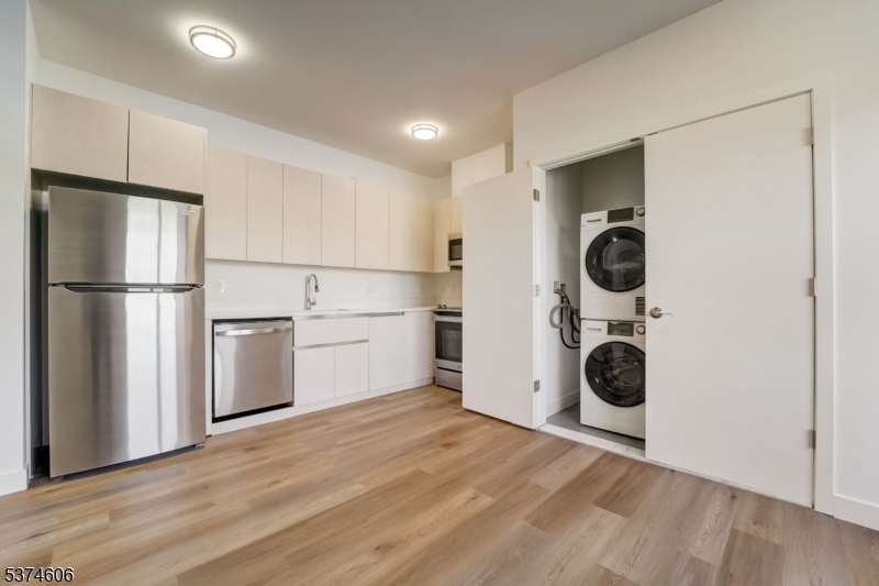 48 Chadwick Street, Unit 203 Paterson, NJ 07503 - Photo 2 of 16 a view of a kitchen with a washer and dryer