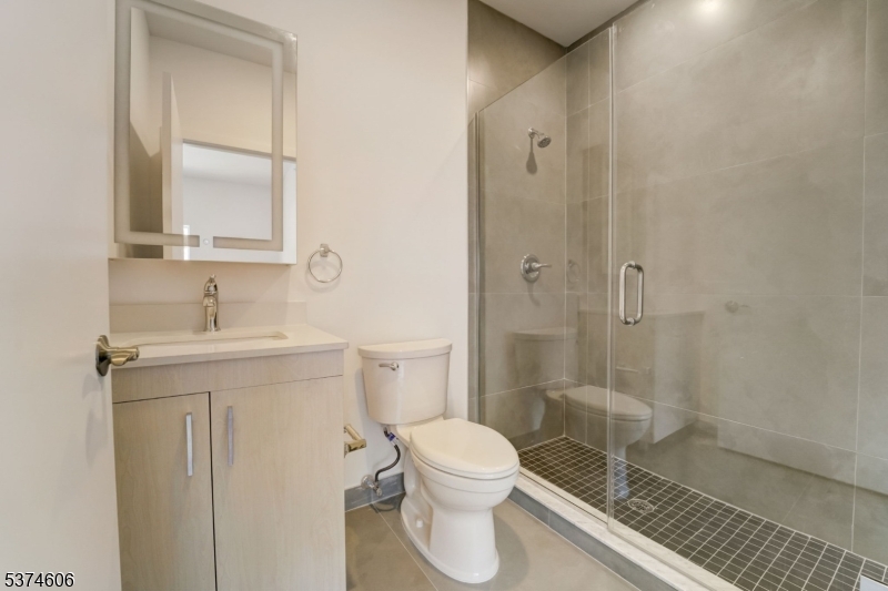 48 Chadwick Street, Unit 203 Paterson, NJ 07503 - Photo 6 of 16 a bathroom with a sink a toilet and shower