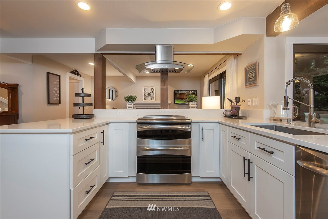 129 200th Place Southeast Bothell, WA 98012 - Photo 11 of 40 a kitchen with granite countertop a sink stainless steel appliances and cabinets