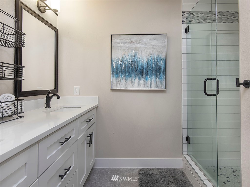 129 200th Place Southeast Bothell, WA 98012 - Photo 29 of 40 a bathroom with a shower sink and mirror