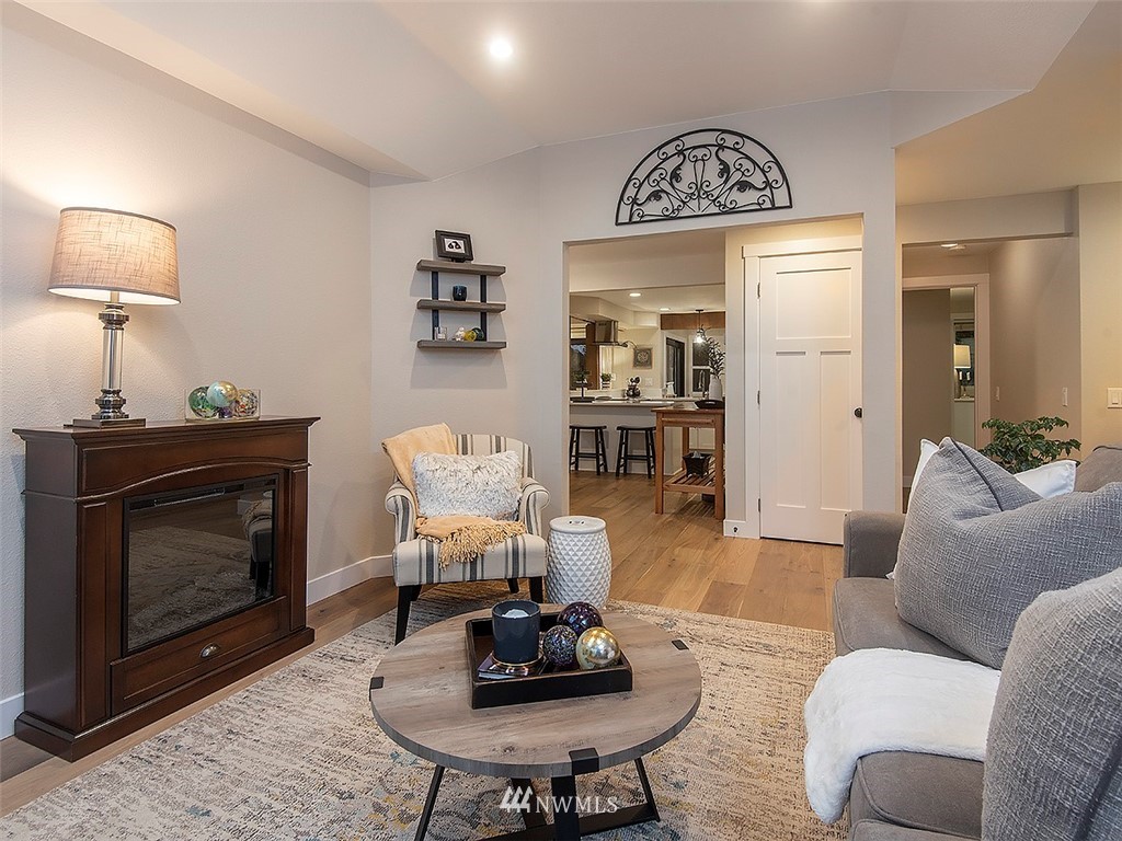129 200th Place Southeast Bothell, WA 98012 - Photo 7 of 40 a living room with furniture a mirror and a fireplace