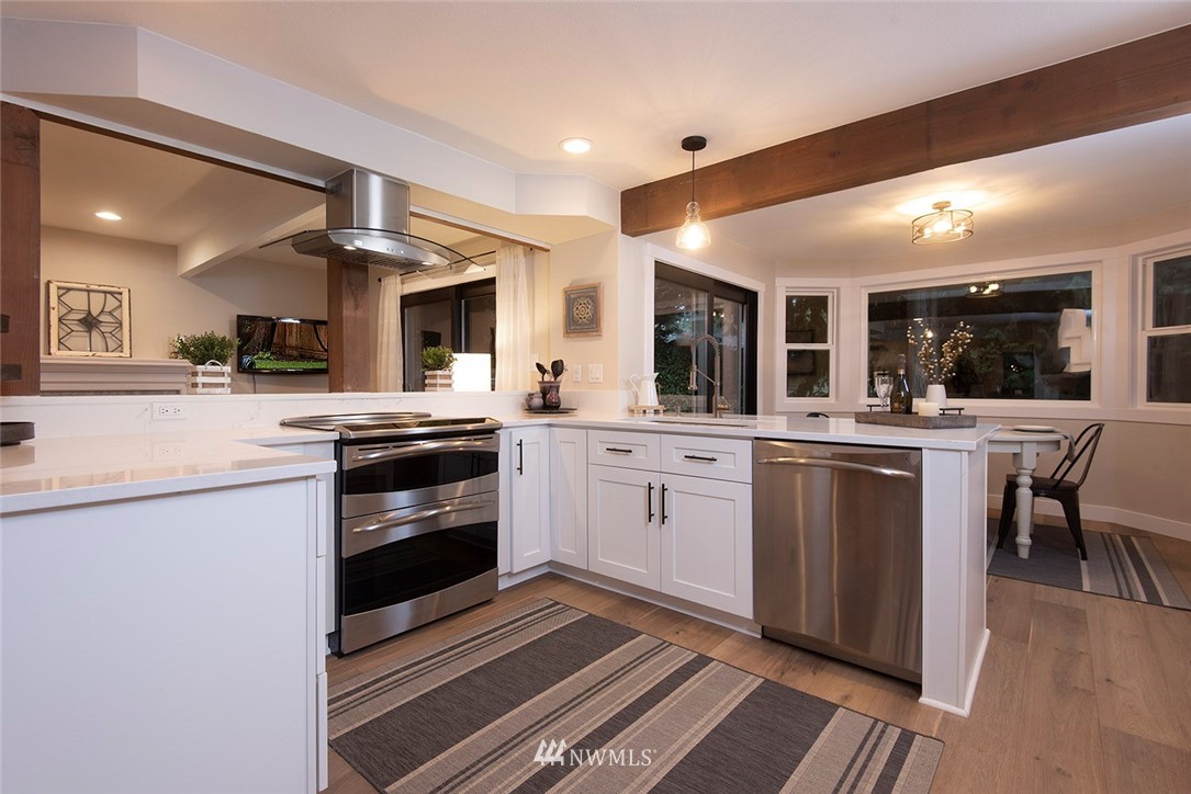 129 200th Place Southeast Bothell, WA 98012 - Photo 10 of 40 a kitchen with stainless steel appliances a sink stove and cabinets