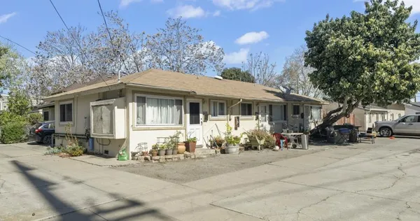 a front view of a house with a sitting area