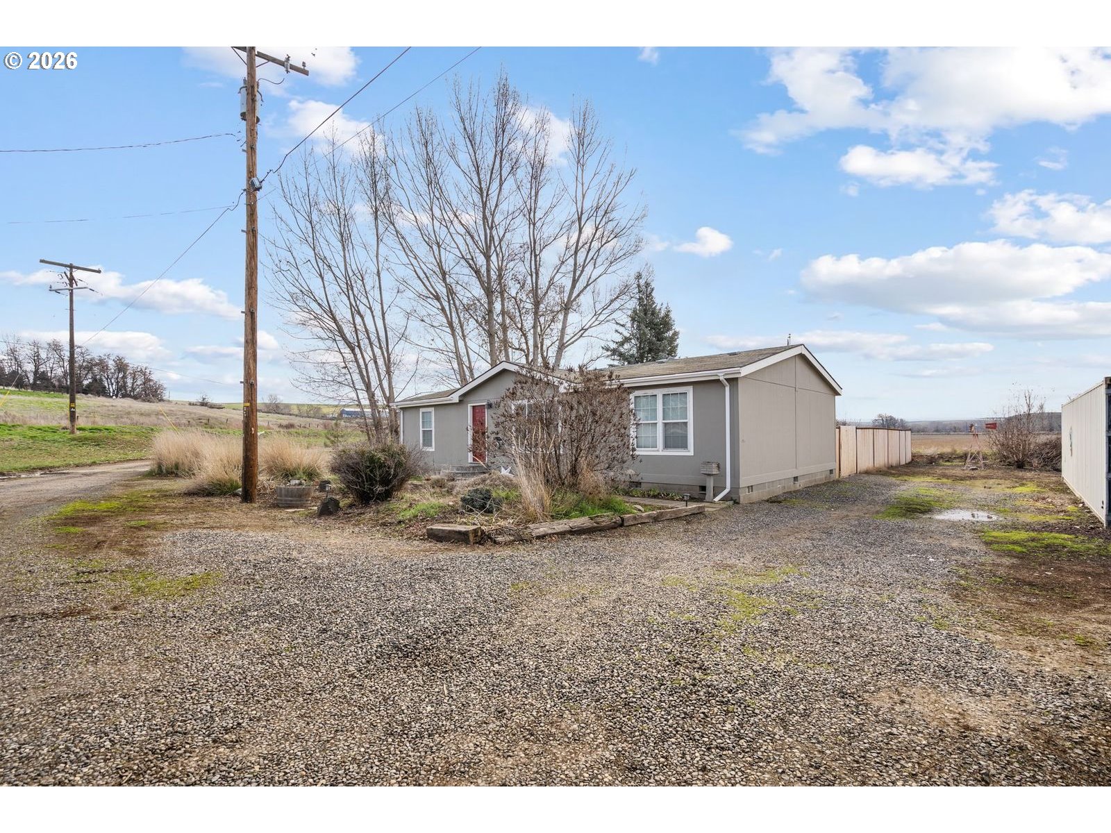 910 East College Echo, OR 97826 - Photo 1 of 23 a view of a old house next to a yard with wooden fence