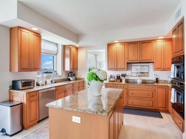 a living room with furniture a fireplace and a large window