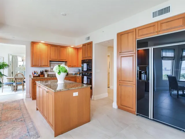 a view of a patio with a table chairs and a backyard