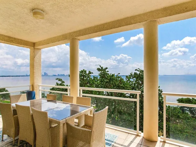 a view of a swimming pool with outdoor seating