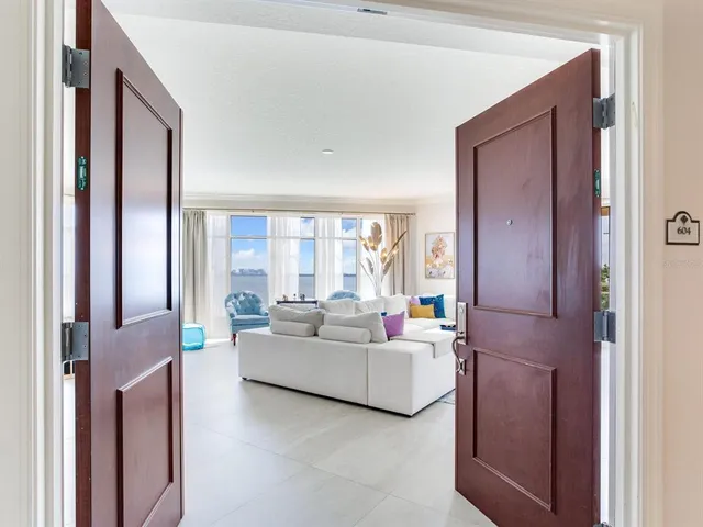 a dining room with wooden floor a chandelier a wooden table and chairs
