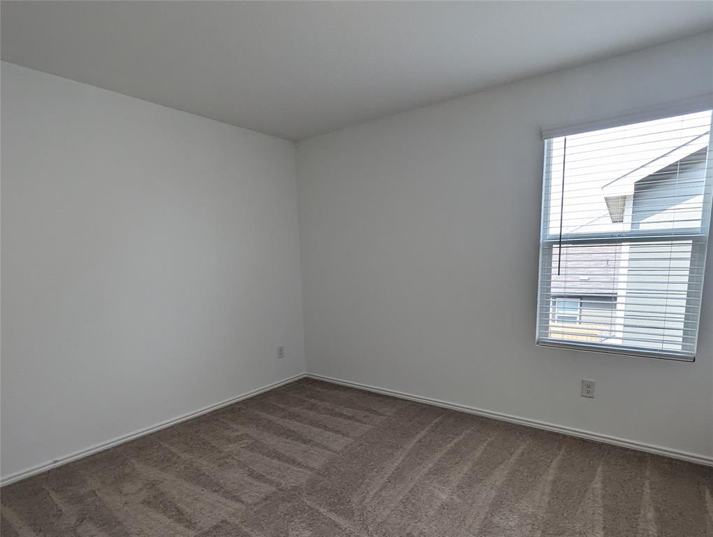 152 Avre Loop Kyle, TX 78640 - Photo 19 of 24 An inviting room provides a neutral canvas for personalization with durable carpet flooring.