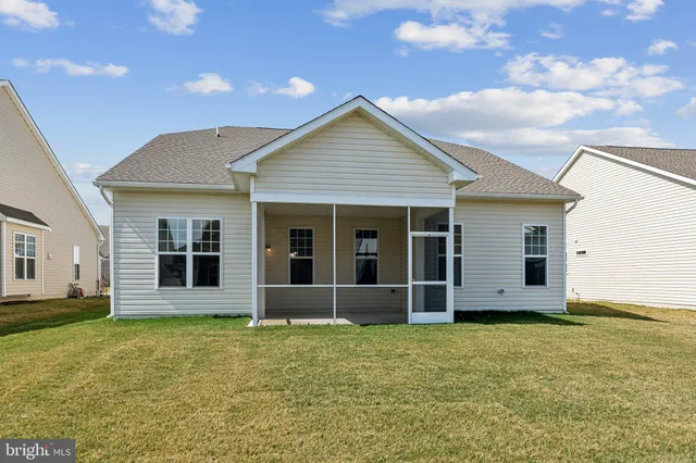a view of a house with wooden fence