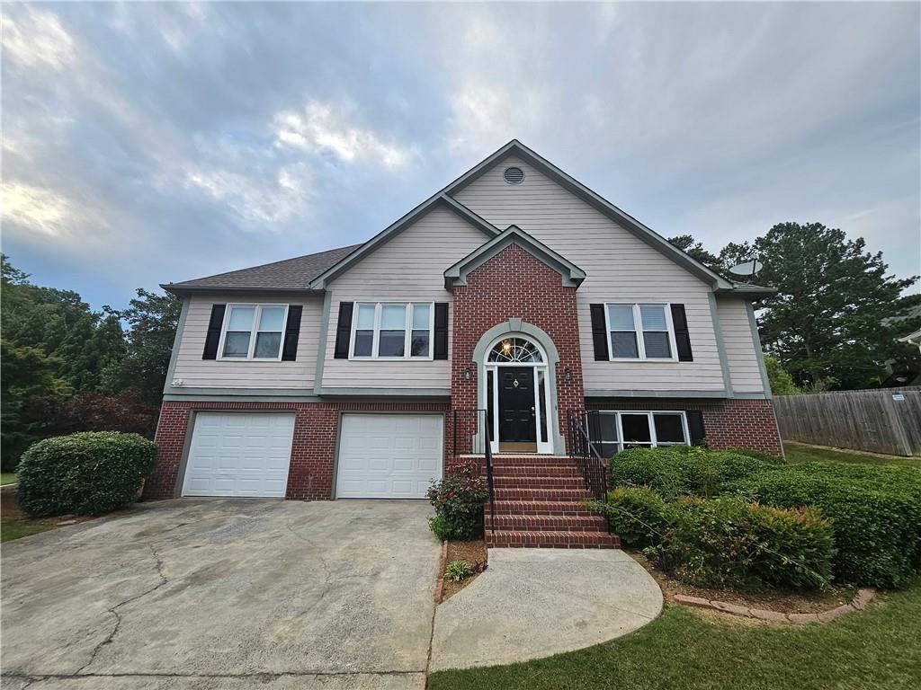 144 Hunters Trace Dallas, GA 30157 - Photo 1 of 34 a front view of a house with garage