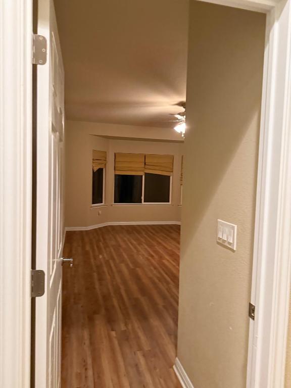 235 Red Poppy Trail Georgetown, TX 78633 - Photo 11 of 21 a view of an empty room with wooden floor and a window