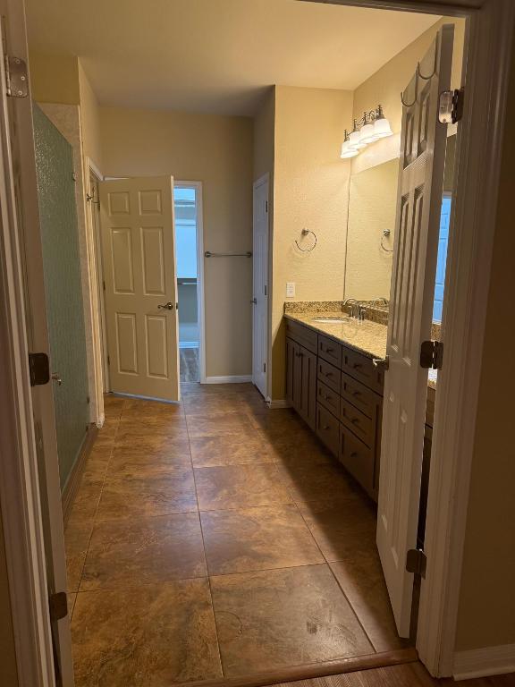 235 Red Poppy Trail Georgetown, TX 78633 - Photo 16 of 21 a bathroom with a tub shower vanity and a sink