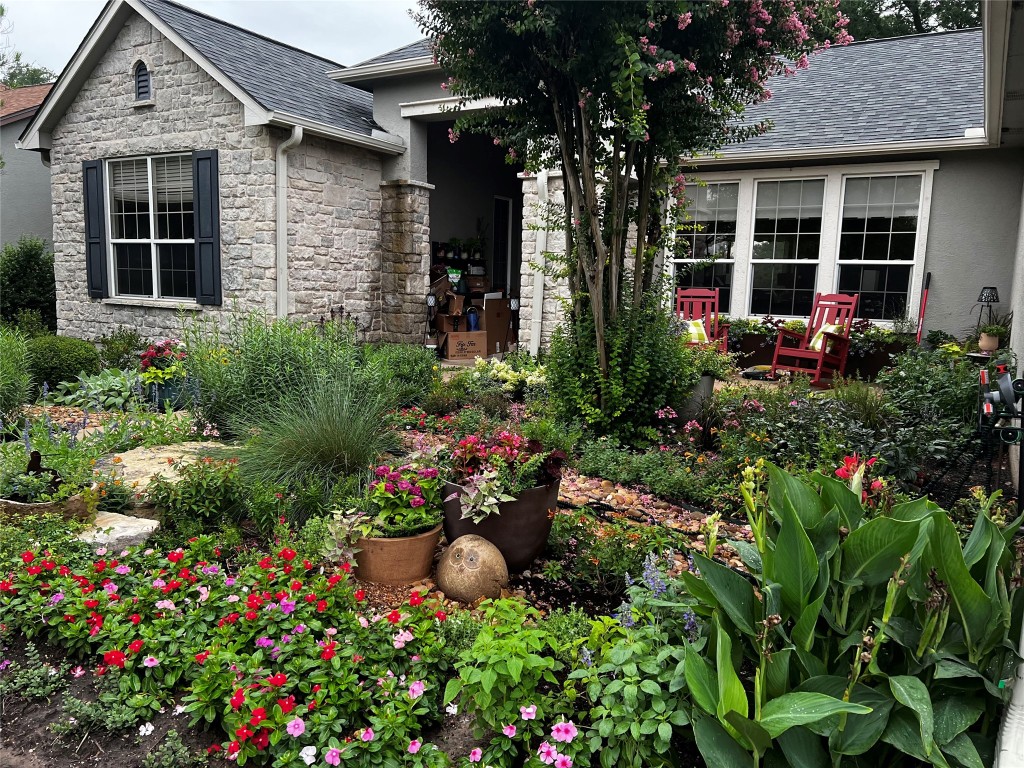 235 Red Poppy Trail Georgetown, TX 78633 - Photo 2 of 21 front view of a house with a flower garden