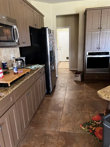 a kitchen with stainless steel appliances a stove a sink and a refrigerator