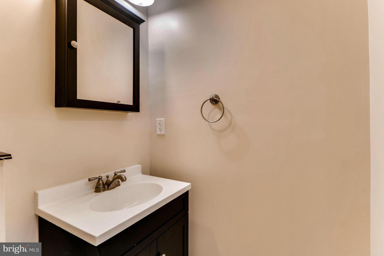 4701 Falls Road Baltimore, MD 21209 - Photo 18 of 28 a bathroom with a sink and a mirror