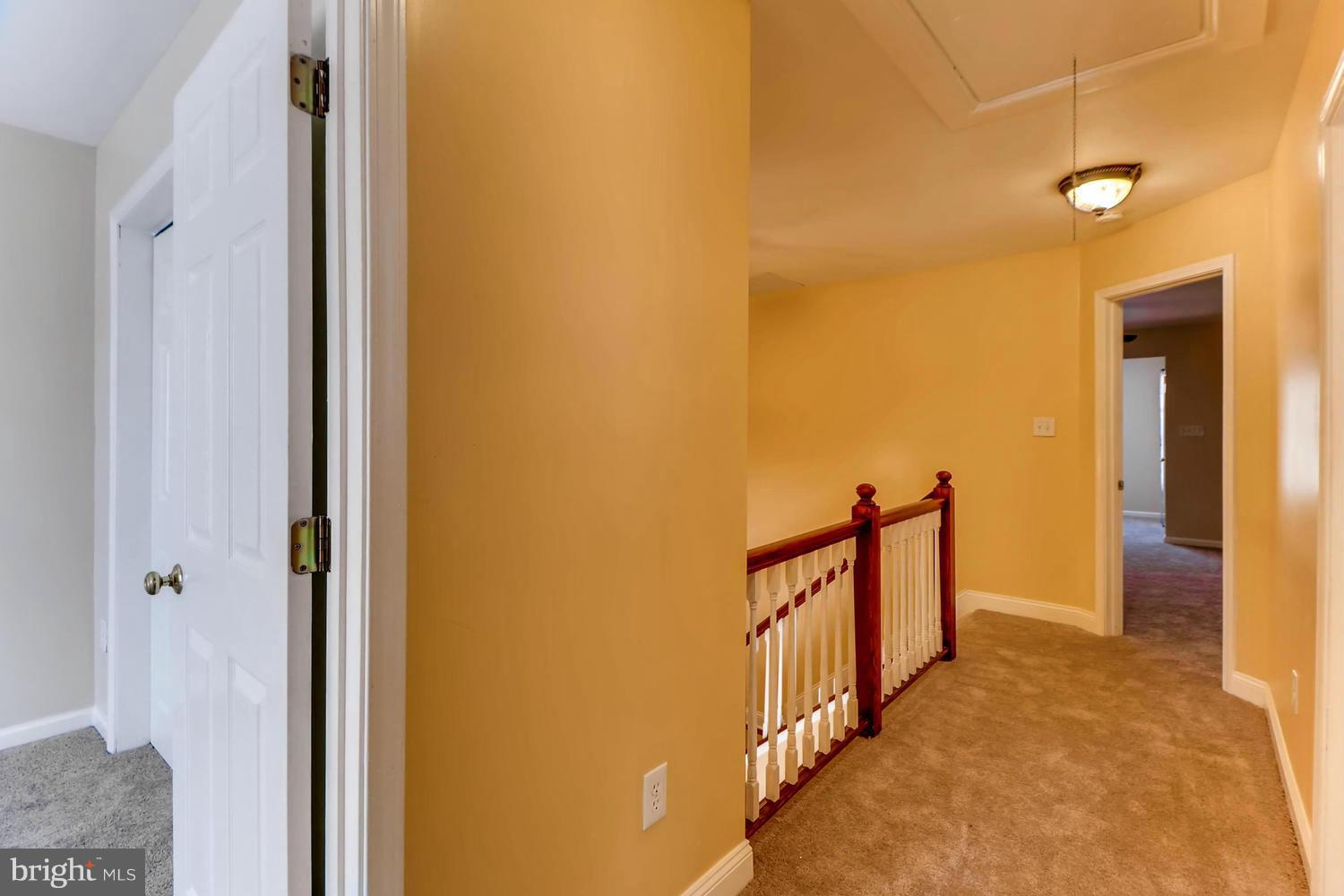 4701 Falls Road Baltimore, MD 21209 - Photo 20 of 28 a view of a hallway with wooden floor and staircase