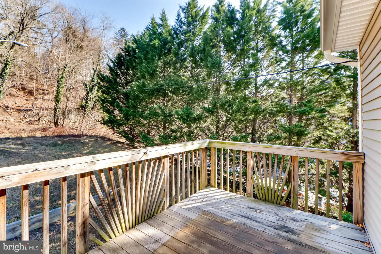 4701 Falls Road Baltimore, MD 21209 - Photo 22 of 28 a balcony with wooden floor and fence