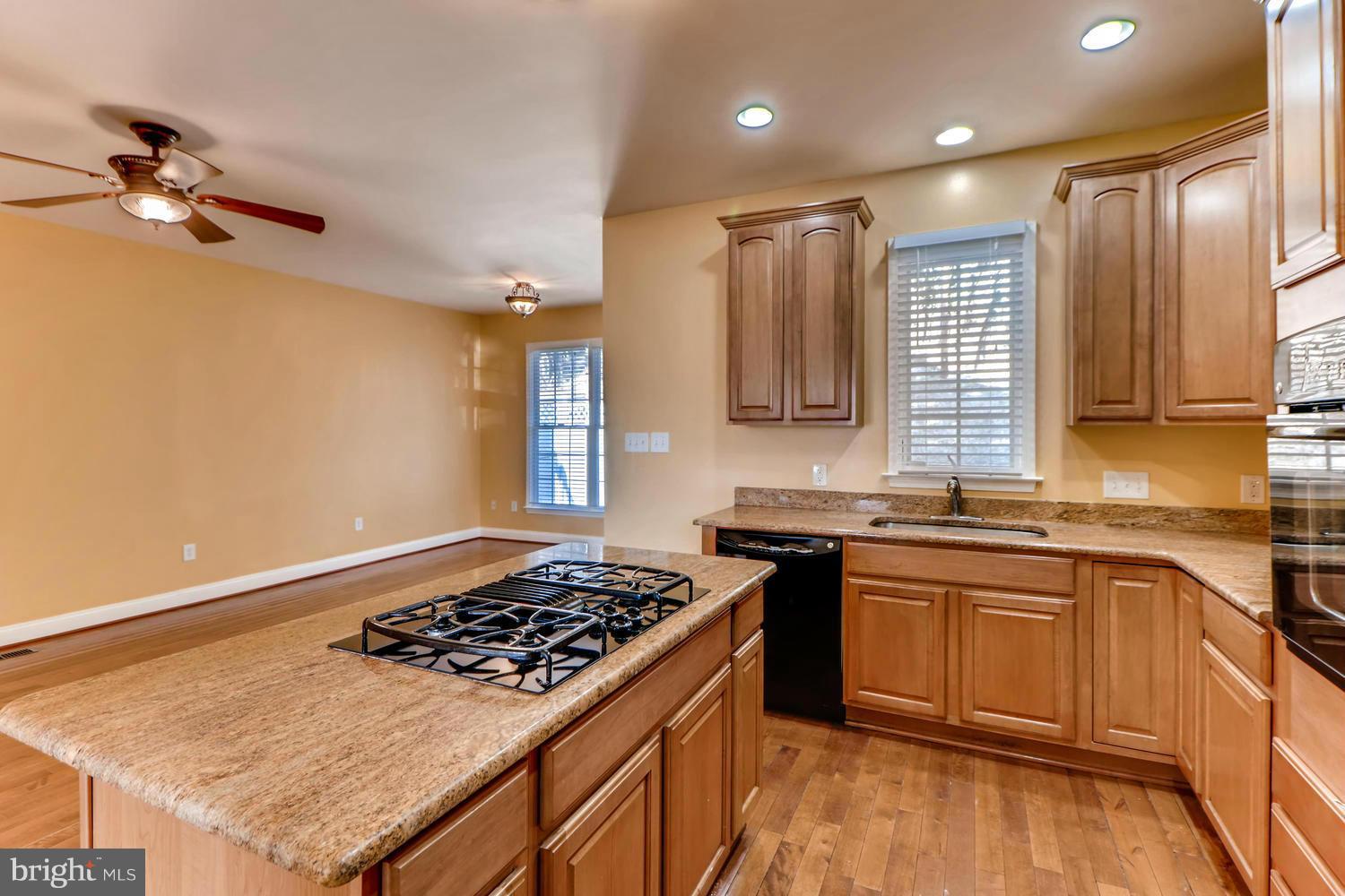 4701 Falls Road Baltimore, MD 21209 - Photo 5 of 28 a kitchen with stainless steel appliances a sink stove and cabinets