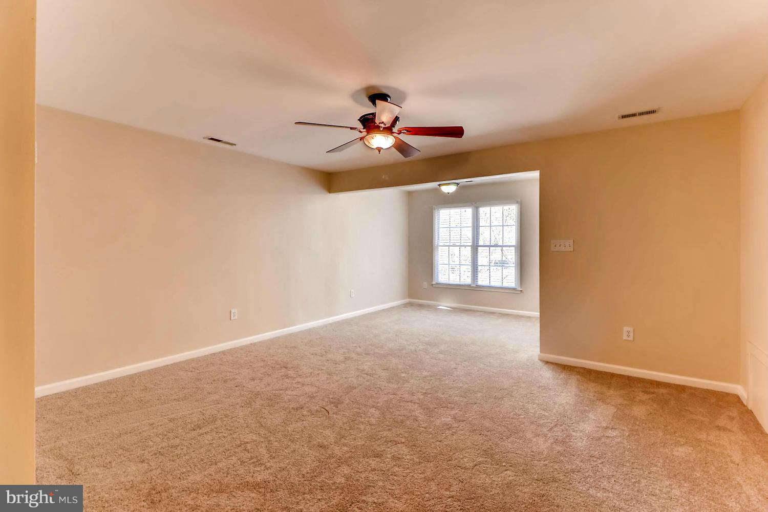 4701 Falls Road Baltimore, MD 21209 - Photo 10 of 28 an empty room with windows and fan