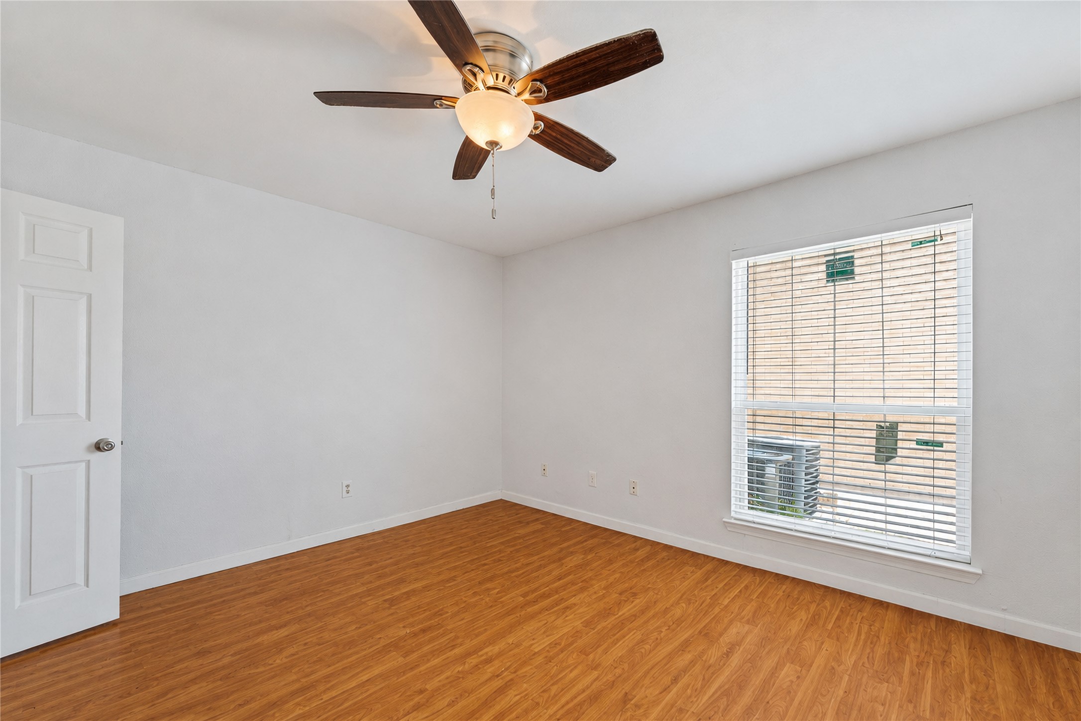 2124 Burton Drive, Unit 159 Austin, TX 78741 - Photo 15 of 23 A quiet retreat with durable hardwood flooring and a refreshing ceiling fan.