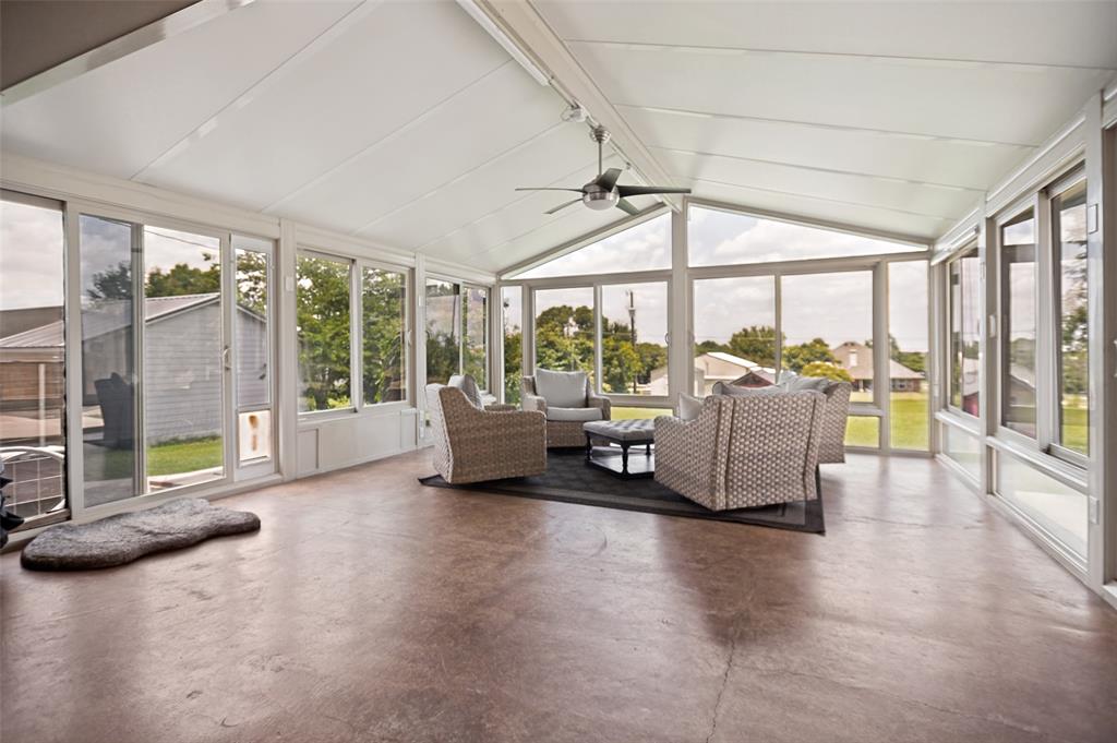 5643 West Caylor Road Fort Worth, TX 76244 - Photo 29 of 37 Heated/AC Sunroom featuring an expansive window wall, vaulted ceiling, sealed concrete flooring, and a ceiling fan