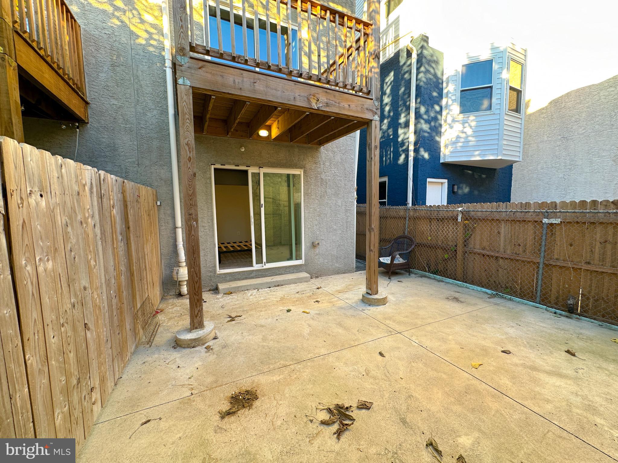 2404 West Thompson Street, Unit A Philadelphia, PA 19121 - Photo 12 of 13 a view of a house with a wooden fence