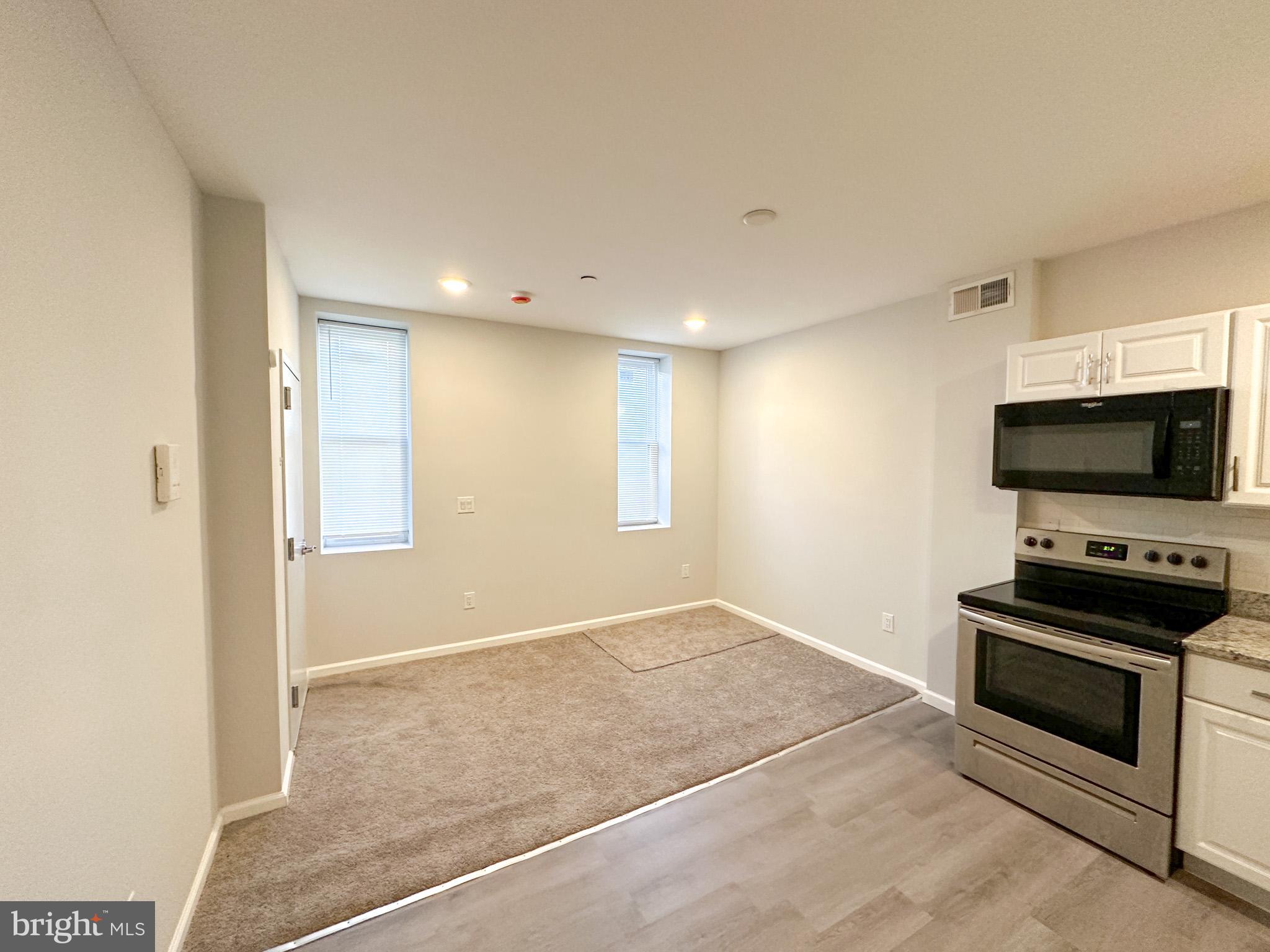 2404 West Thompson Street, Unit A Philadelphia, PA 19121 - Photo 2 of 13 a view of kitchen with microwave and stove