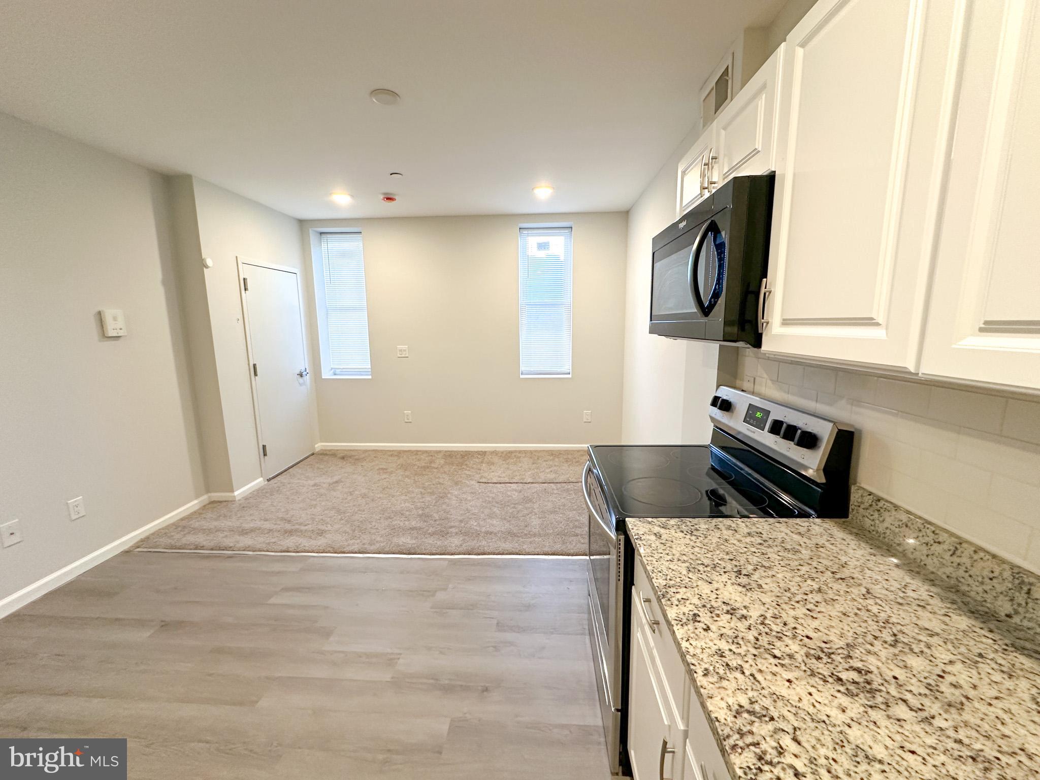 2404 West Thompson Street, Unit A Philadelphia, PA 19121 - Photo 3 of 13 a kitchen with a sink cabinets and a wooden floor