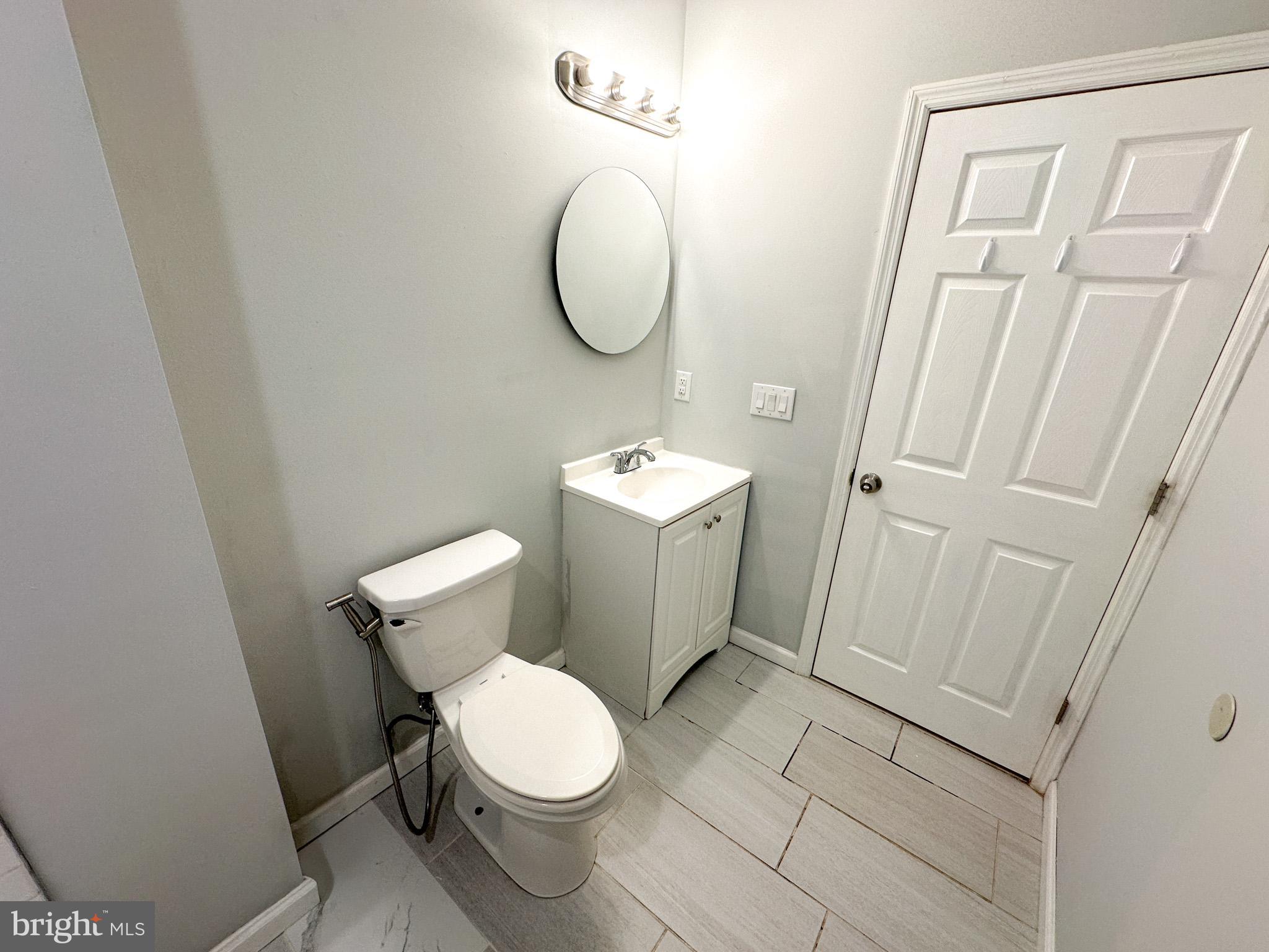 2404 West Thompson Street, Unit A Philadelphia, PA 19121 - Photo 6 of 13 a white toilet sitting next to a bathroom sink