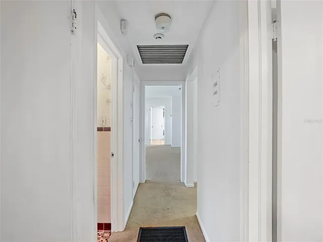 a view of a hallway with a white walls