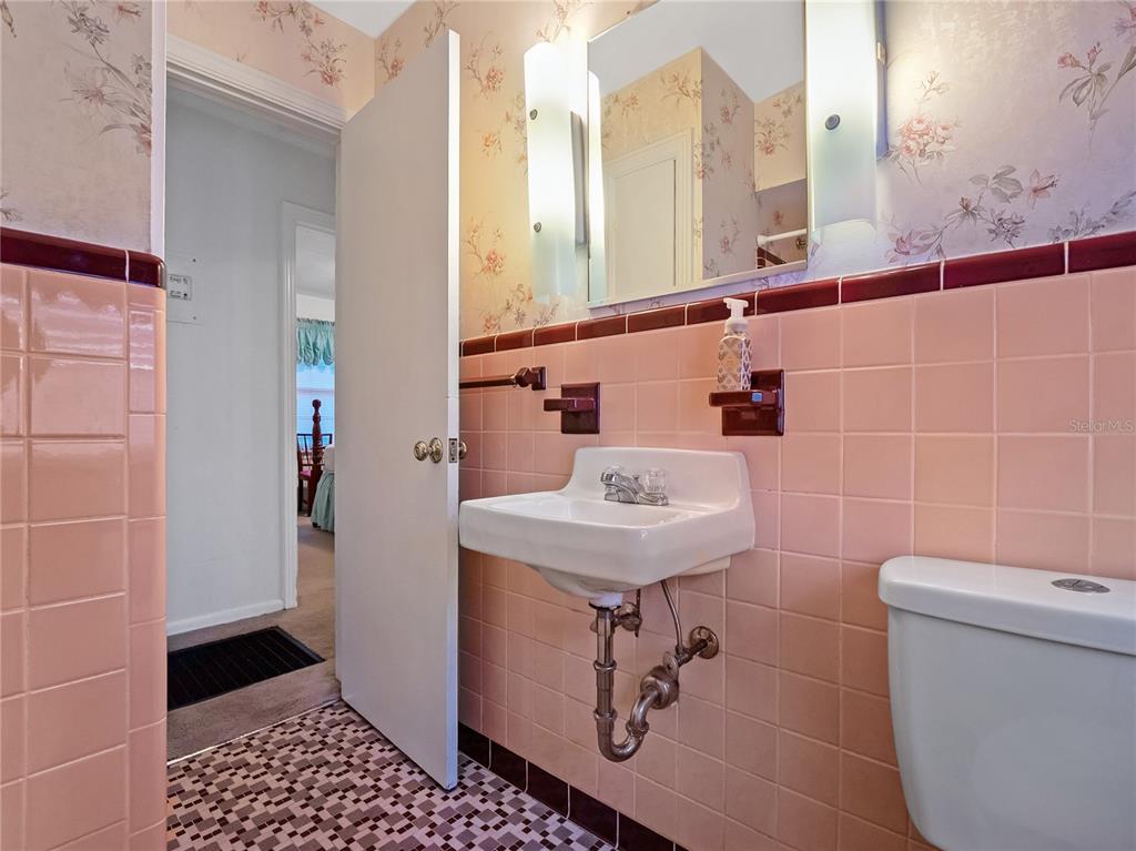 1631 Southeast 17th Street Ocala, FL 34471 - Photo 15 of 36 a bathroom with a sink a toilet and a mirror