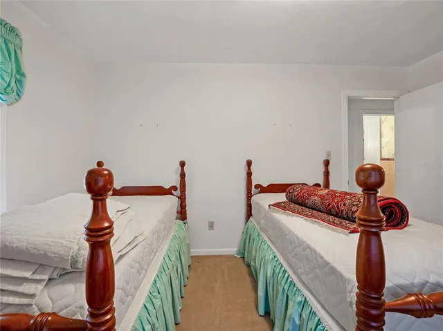 a bedroom with two beds and a window