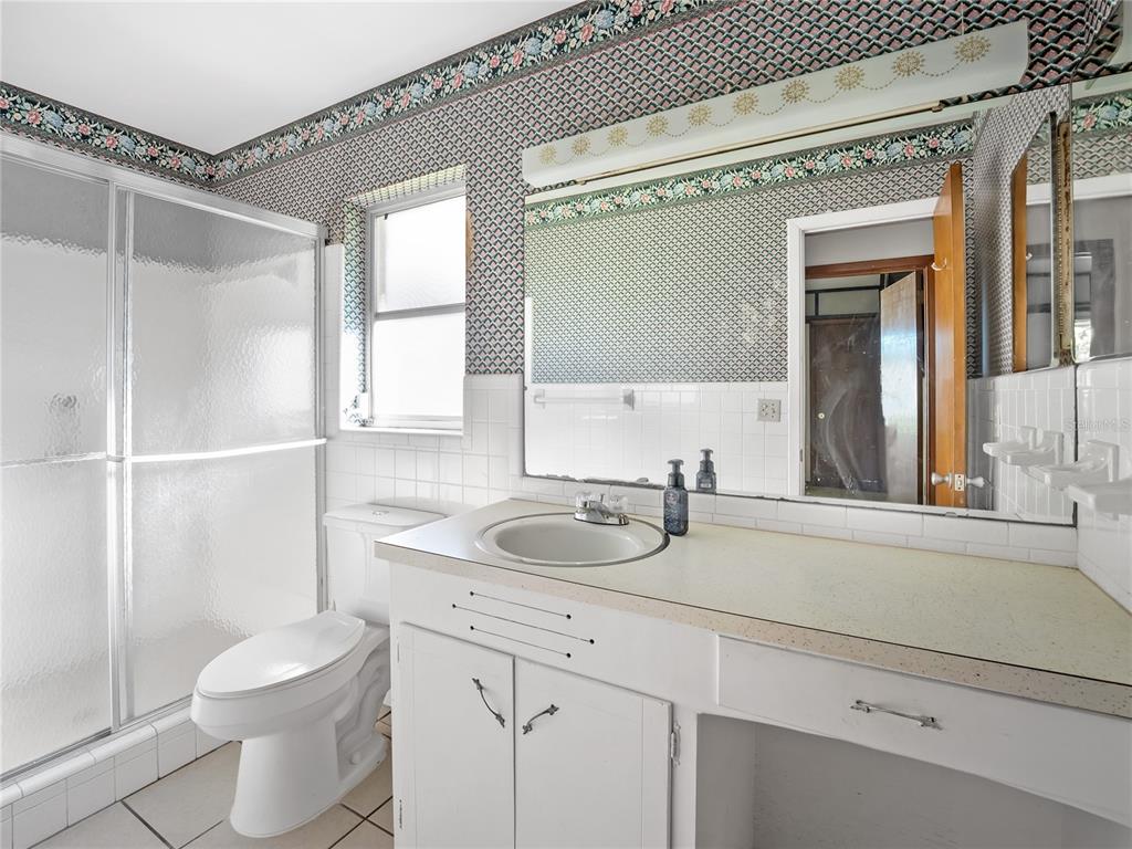 1631 Southeast 17th Street Ocala, FL 34471 - Photo 25 of 36 a bathroom with a sink toilet and shower