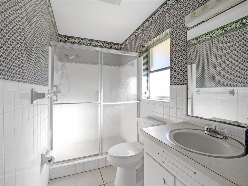 1631 Southeast 17th Street Ocala, FL 34471 - Photo 26 of 36 a bathroom with a sink toilet and shower