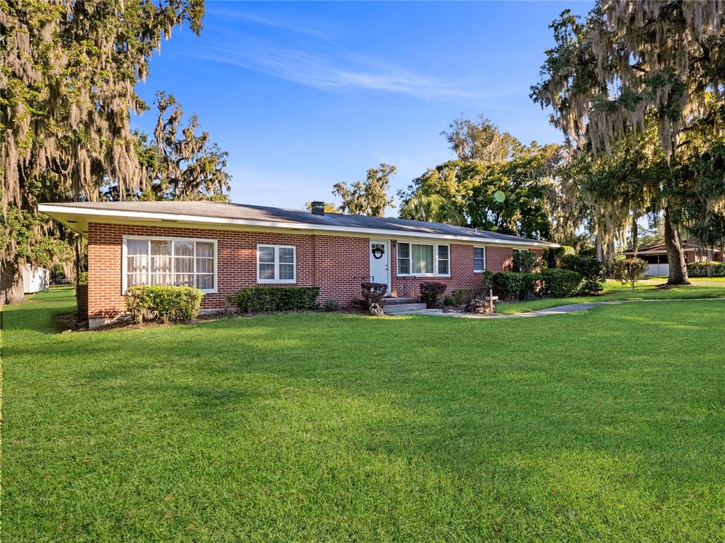 1631 Southeast 17th Street Ocala, FL 34471 - Photo 34 of 36 front view of a house with a garden