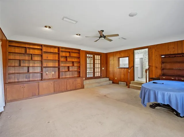 a large bedroom with a large bed and a flat tv screen