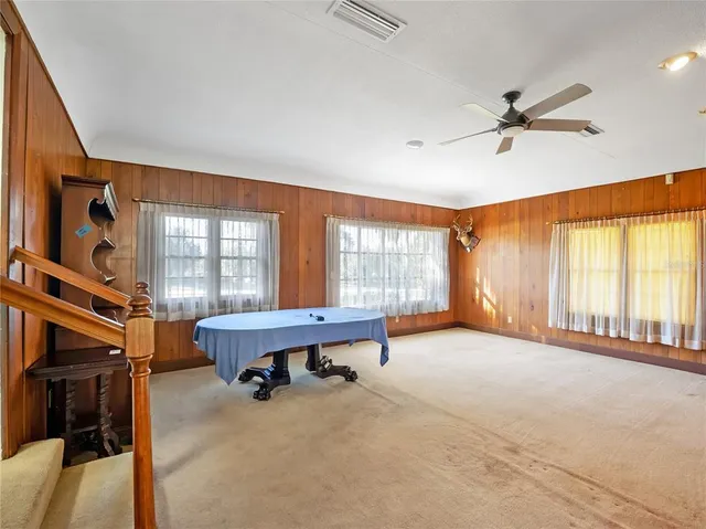 a large bedroom with a bed and a large window