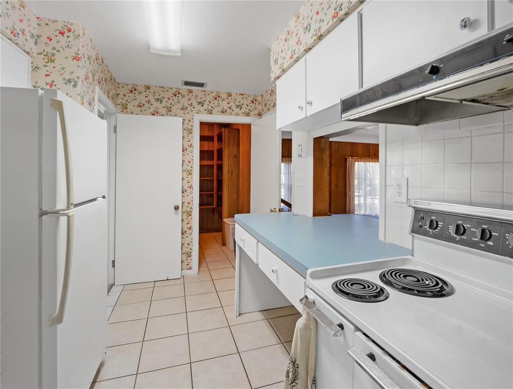 1631 Southeast 17th Street Ocala, FL 34471 - Photo 10 of 36 a kitchen with a stove and a refrigerator