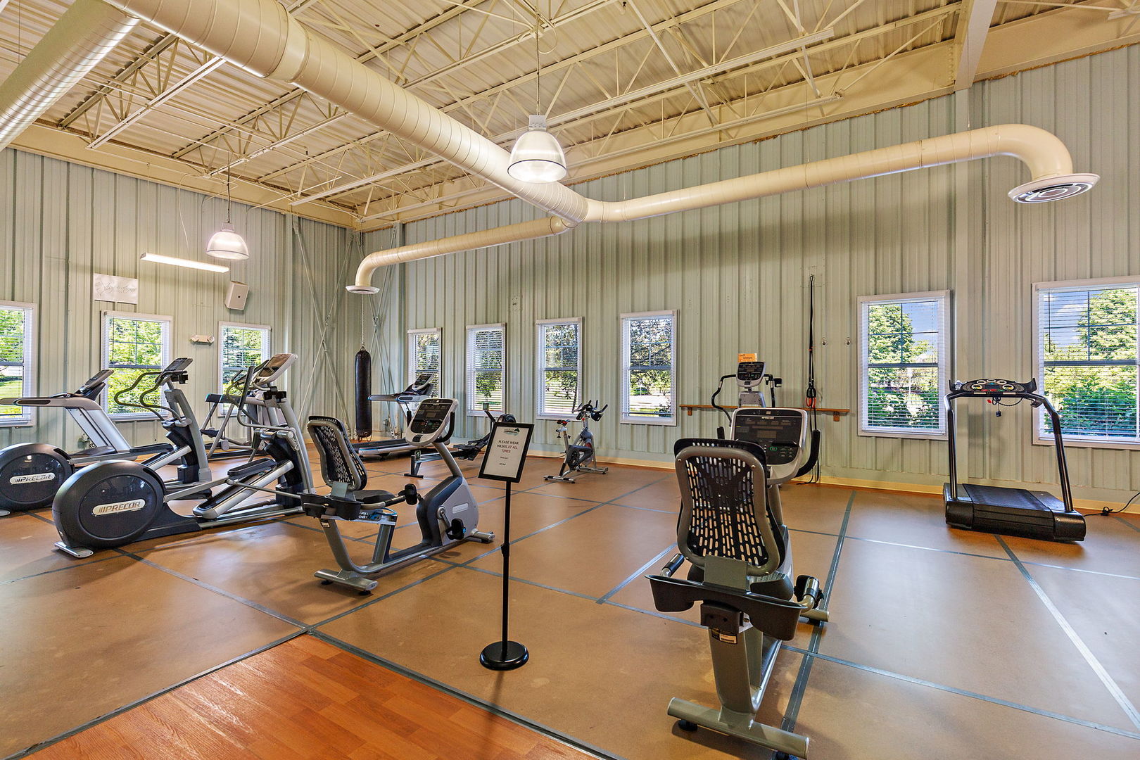 2360 Upland Road, Unit 2267 Hampshire, IL 60140 - Photo 24 of 26 a living room with furniture gym equipment and a large window