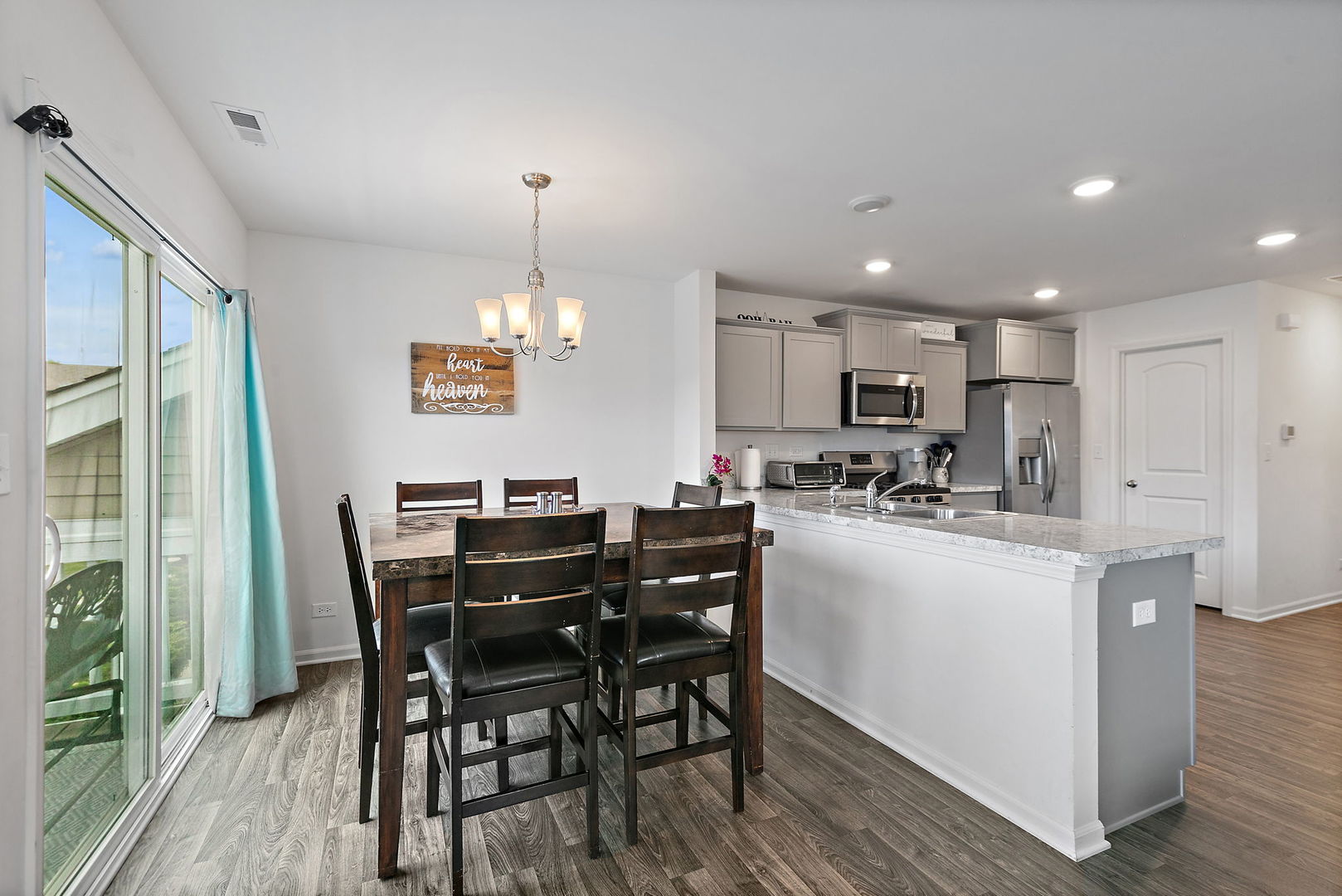 2360 Upland Road, Unit 2267 Hampshire, IL 60140 - Photo 6 of 26 a view of a dining room with furniture and wooden floor