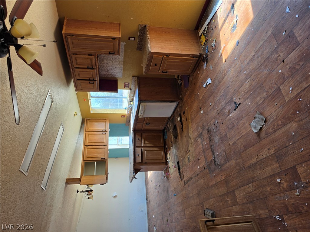 4231 West Wilson Road Pahrump, NV 89048 - Photo 15 of 19 Wood cabinets and stone counters define this kitchen space awaiting renovation.