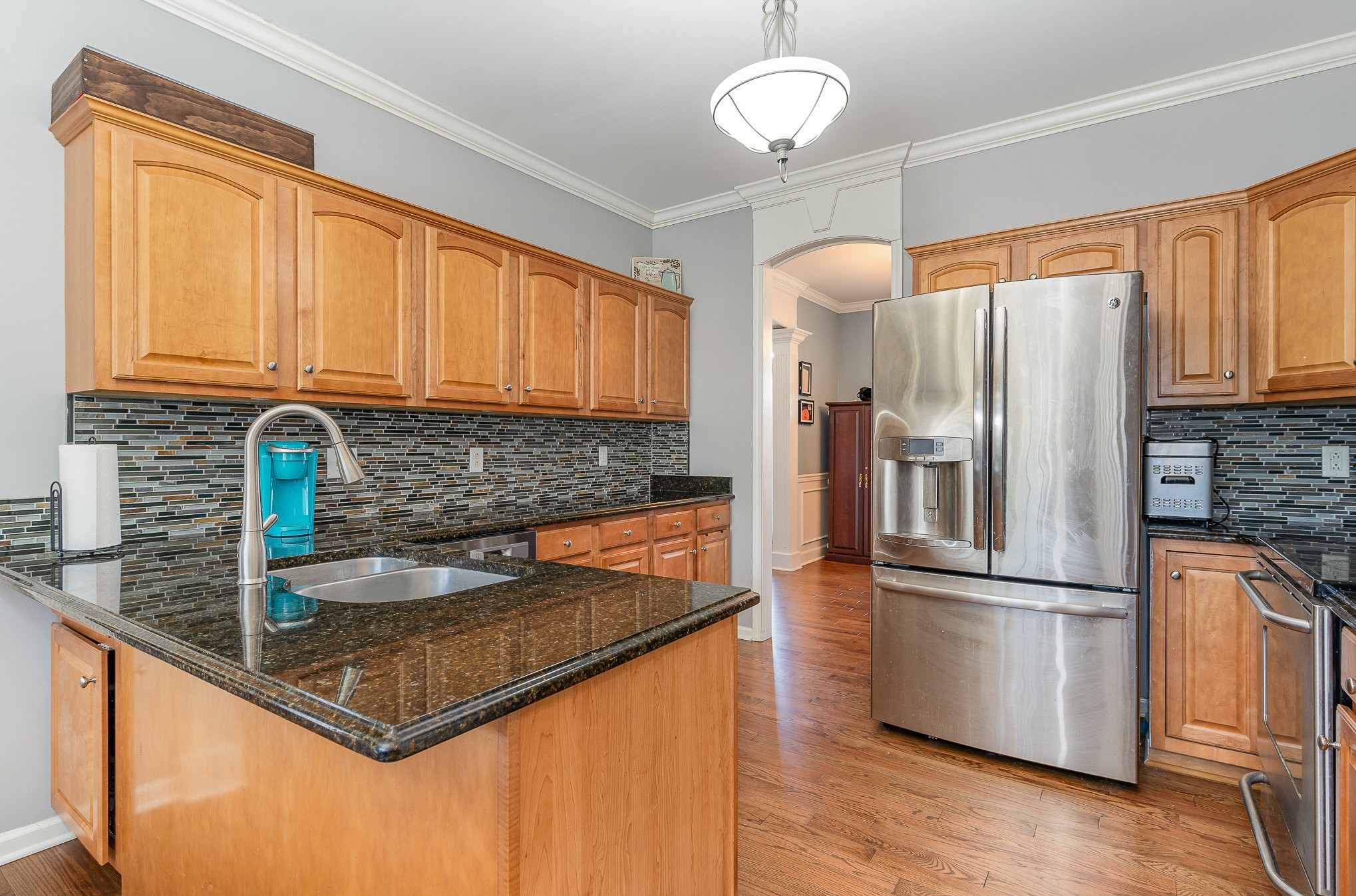 242 Foundry Circle Murfreesboro, TN 37128 - Photo 10 of 26 a kitchen with kitchen island granite countertop a sink appliances cabinets and counter space