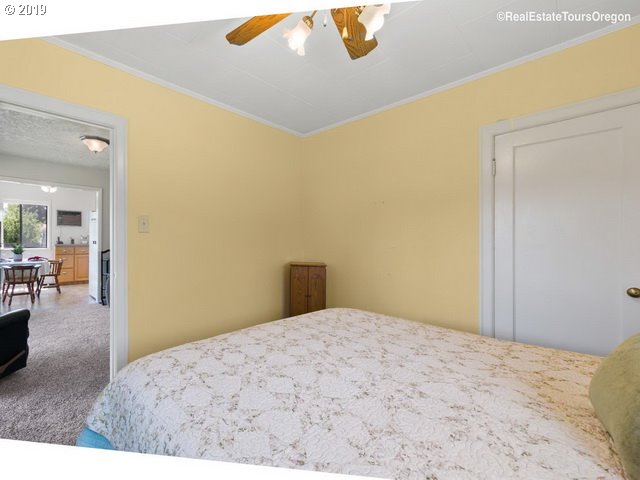 24311 South Larkin Road Beavercreek, OR 97004 - Photo 12 of 31 a bedroom with a bed and mirror