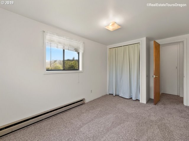 24311 South Larkin Road Beavercreek, OR 97004 - Photo 16 of 31 an empty room with windows and closet
