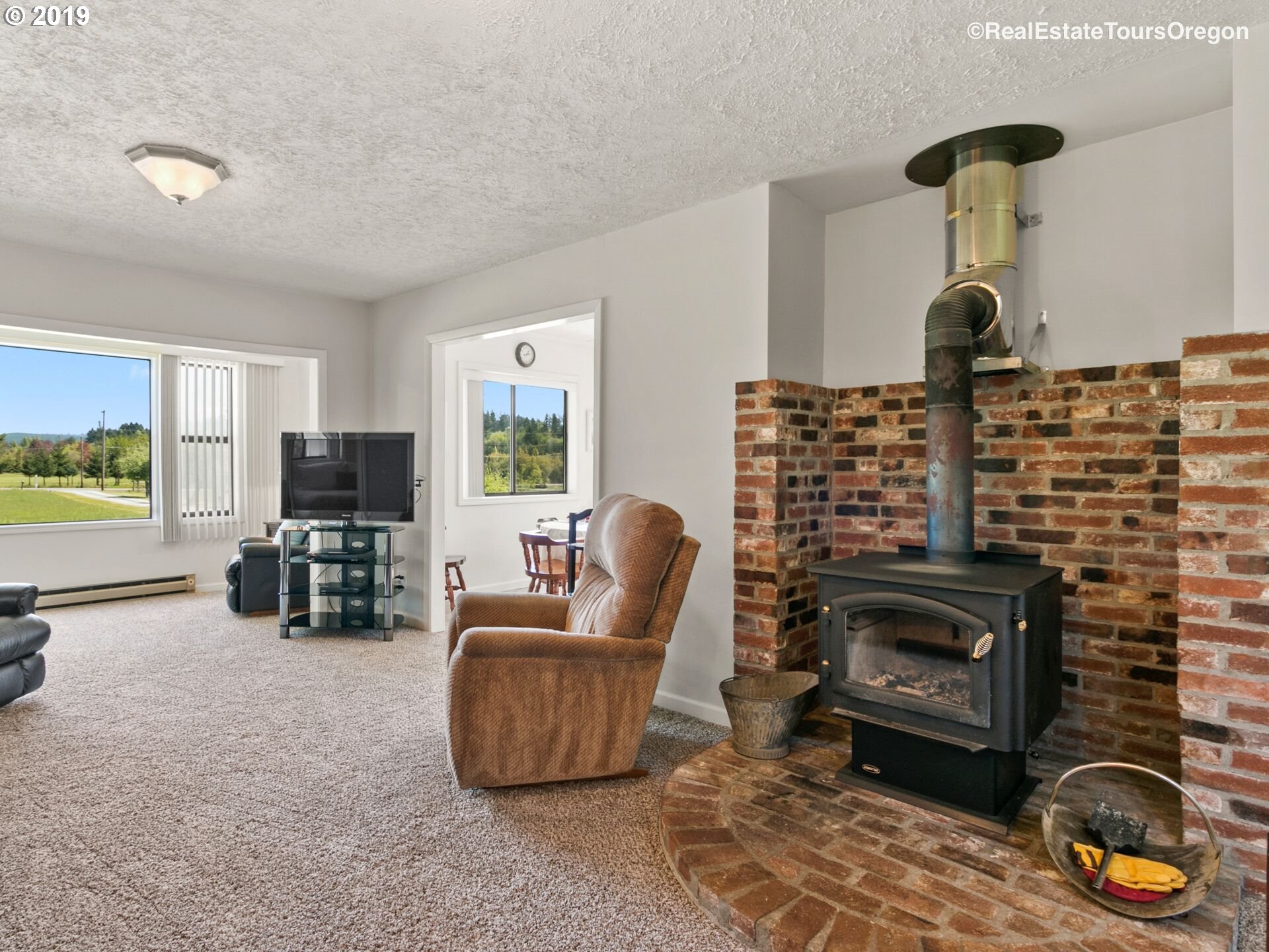 24311 South Larkin Road Beavercreek, OR 97004 - Photo 4 of 31 a living room with furniture and a fireplace